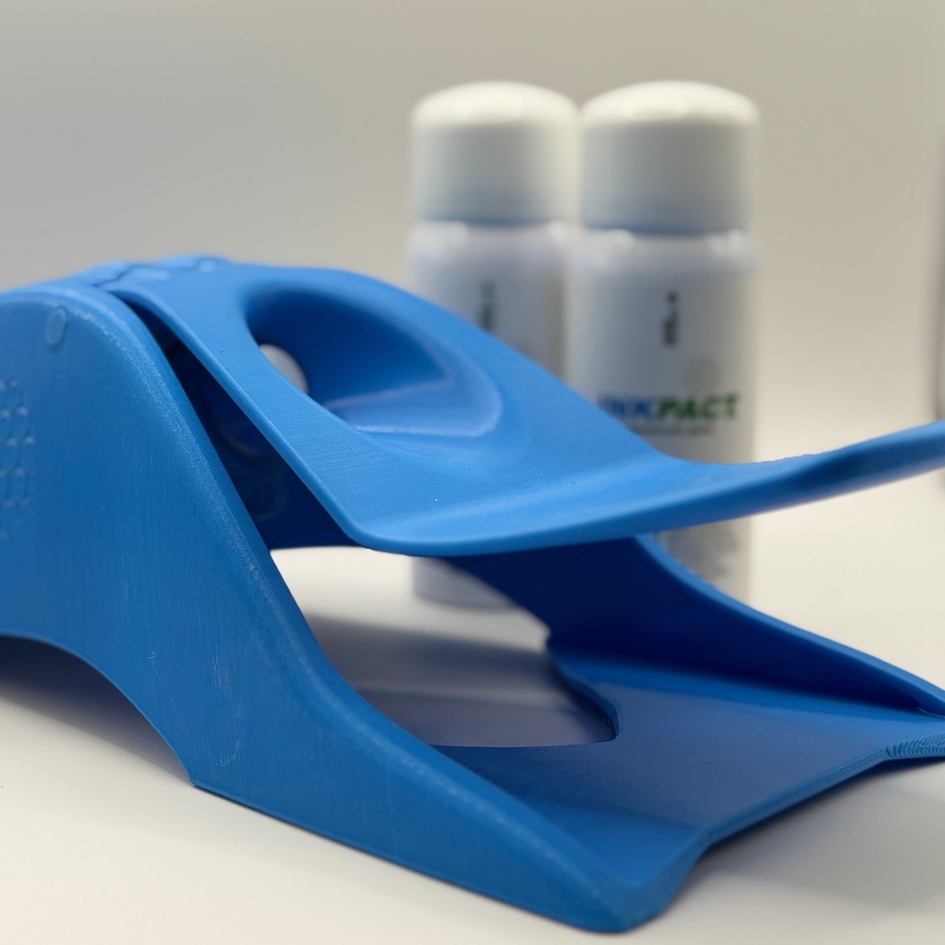 Blue  Golf Impact Printer on a white surface with two white VT Cartridges in the background