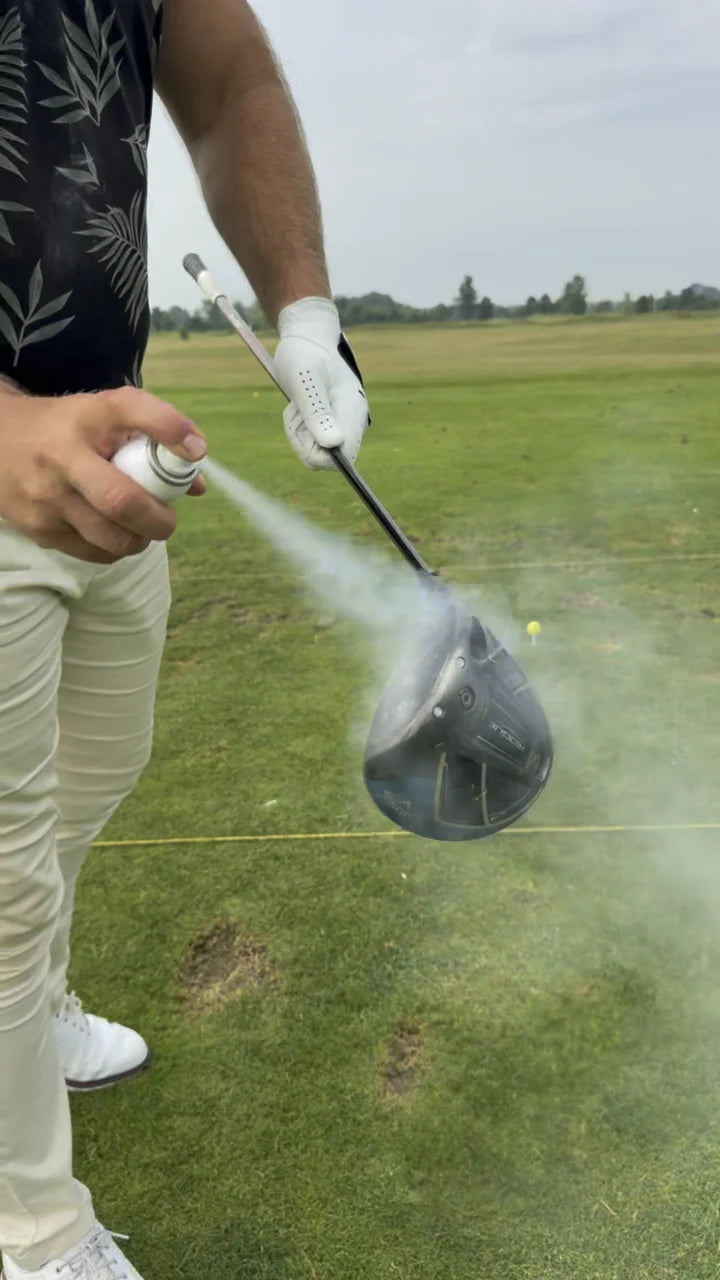 Golf impact spray being applied to a clubface